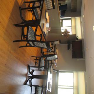 A spacious and modern dining area featuring wooden furniture and ample natural light.