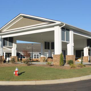 A modern building with a welcoming entrance and well-maintained landscaping.