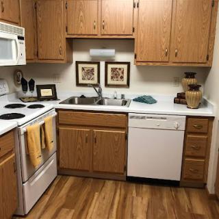 A cozy kitchen featuring wooden cabinets and modern appliances.