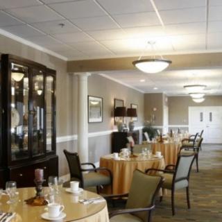 A well-appointed dining room with elegantly set tables and comfortable chairs.