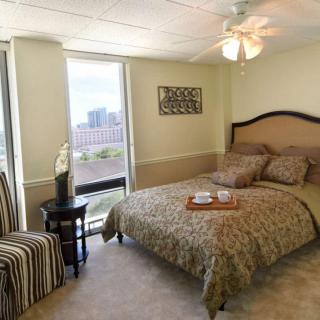 A cozy bedroom with a cityscape view and decorative elements.