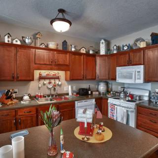 A cozy kitchen with wooden cabinets and modern appliances.