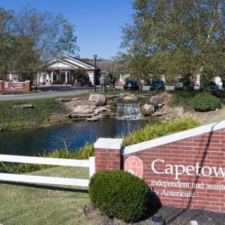 Scenic view of Capetown Independent & Assisted Living with a pond and landscaped surroundings.