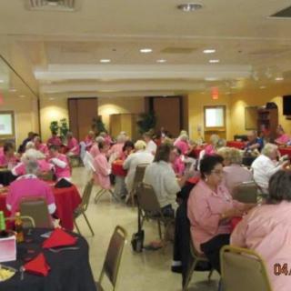 A large group of people gathered indoors for a social event.