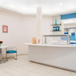 A modern reception area with minimalist design elements and bright lighting.