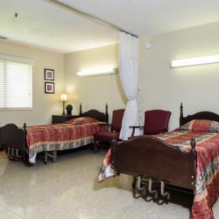 A cozy shared bedroom featuring twin beds and warm lighting.