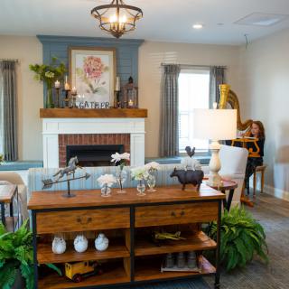 A beautifully decorated living room featuring a fireplace, elegant furniture, and stylish artwork.