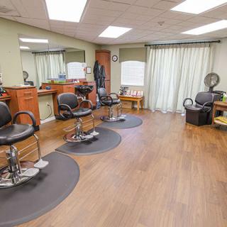 A cozy barbershop with styling chairs and mirrors, ready for customers.