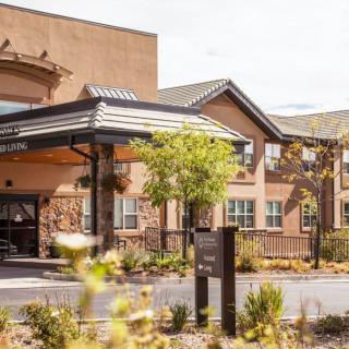 A view of a commercial building with an attractive entrance and landscaped surroundings.
