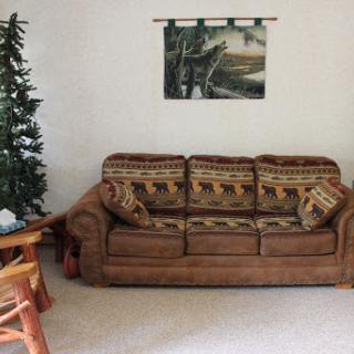 A cozy living room setup featuring a comfortable sofa and a decorative wall piece.