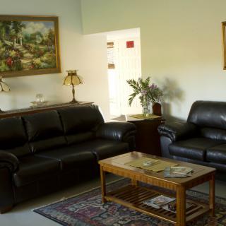 A cozy living room with leather sofas and a wooden coffee table.