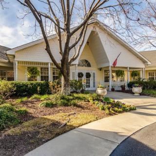 A welcoming residential building with a landscaped garden and winding walkway.