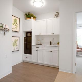 Modern kitchen interior with white cabinets and decorative elements.