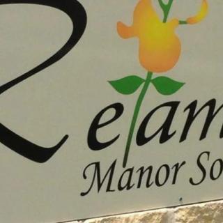A close-up of a sign with floral design and text.