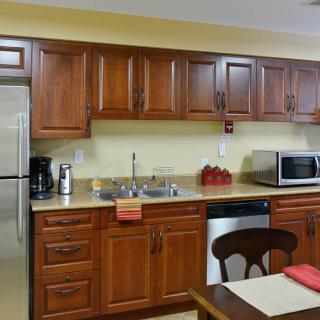 A modern kitchen with wooden cabinets and stainless steel appliances.