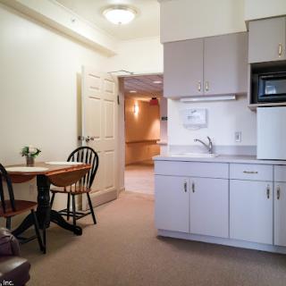 A cozy kitchenette and dining area in a bright apartment.