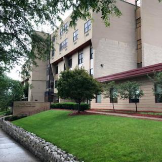 A modern building with well-maintained landscaping and a neatly trimmed lawn.