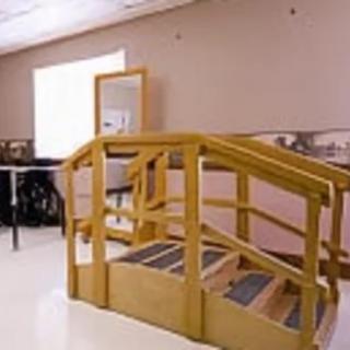 A physical therapy room featuring rehabilitation stairs for exercise.
