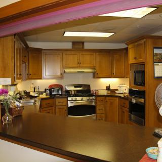 A cozy kitchen with wooden cabinets and modern appliances.