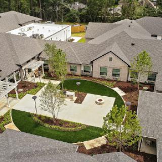 Aerial view of a beautifully landscaped courtyard surrounded by residential buildings.