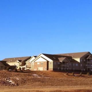 A view of a residential construction site under a clear blue sky.
