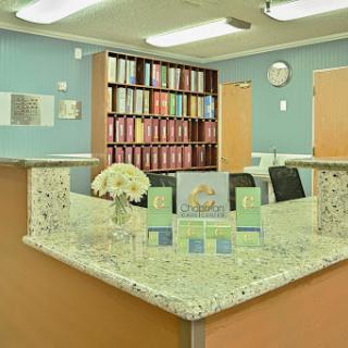A welcoming reception area with organized shelves and decorative flowers.