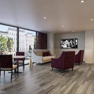 A modern lobby featuring comfortable seating and large windows.