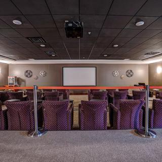 A home theater with comfortable seating and a large projector screen.