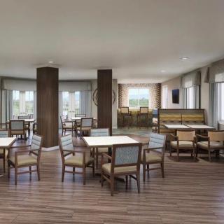 A modern dining area with tables and chairs arranged neatly.