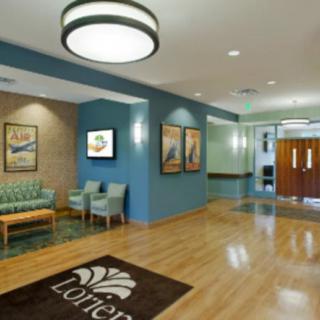 A modern lobby with seating arrangements, artwork on the walls, and a welcoming atmosphere.