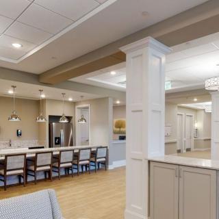 A modern open-concept kitchen and dining area with contemporary lighting and cabinetry.