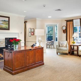 A cozy living room with elegant wooden furniture and decorative accents.