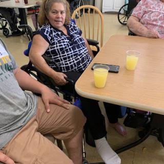A group of elderly individuals enjoying a social moment together.