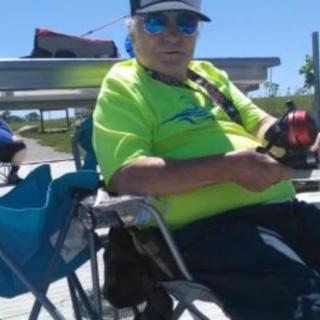 Person relaxing while fishing on a sunny day.