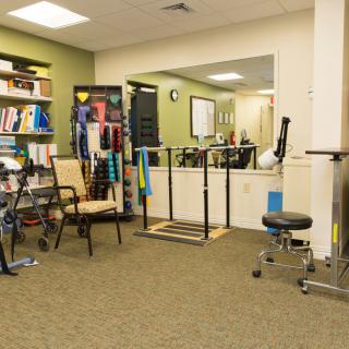 A physical therapy room equipped with various rehabilitation tools and exercise equipment.