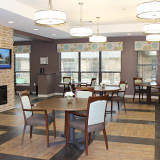 A modern dining area featuring stylish furniture and ample natural light.