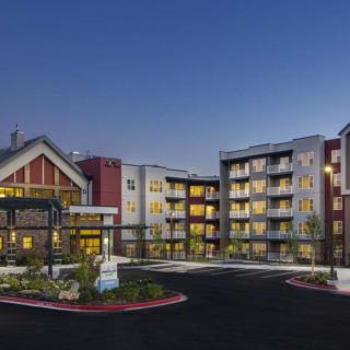A modern apartment complex illuminated at night.