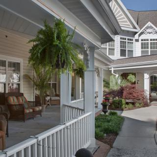 A charming house with a cozy porch and well-maintained garden.