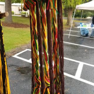 Colorful handmade textile decor showcasing vibrant patterns at an outdoor market.