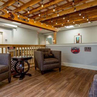 A cozy waiting area with comfortable chairs and decorative lighting.