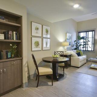 A cozy living room with a small dining area and elegant furniture.