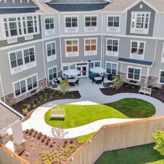 Aerial view of a residential apartment building with a landscaped courtyard.