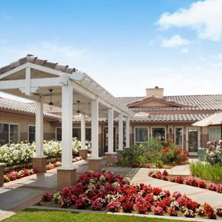 A well-maintained residential building with a beautifully landscaped garden and walkway.