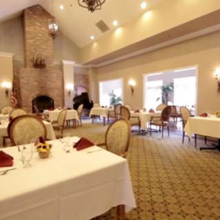 An elegant dining room with neatly arranged tables and chairs, ready for guests.