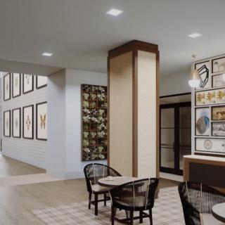 A modern cafe interior featuring artwork on the walls and a cozy seating area.