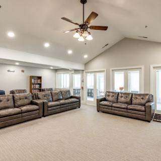 A spacious and inviting living room featuring comfortable seating and ample natural light.