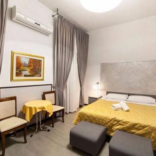 Cozy hotel room with a double bed, stylish decor, and modern amenities.