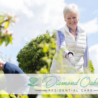 A senior woman gardening outdoors at a residential care facility.