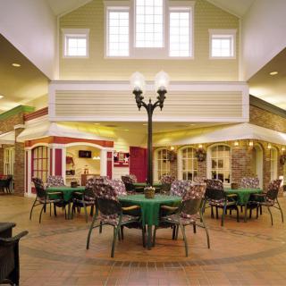 A spacious indoor seating area with tables and chairs, featuring decorative lighting and a stylish interior design.