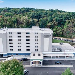 Aerial view of a hospital building surrounded by trees.